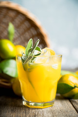 Sweet old-fashioned cocktail with orange and sage. Selective focus. Shallow depth of field.