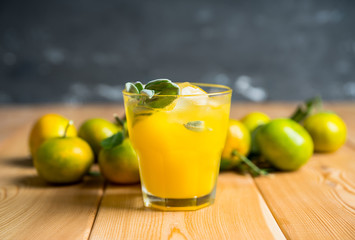 Sweet old-fashioned cocktail with orange and sage. Selective focus. Shallow depth of field.