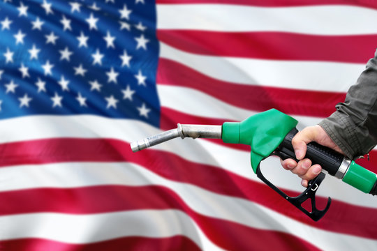 United States Gas Station. Man Pumping Gasoline Fuel In Car With National Flag Background. Oil Prices Concept.