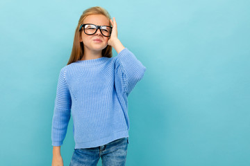 Copyspace photo stylish modern girl on a background of blue wall with glasses for vision, concept of visually impaired person