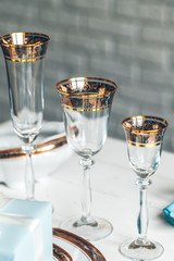Close up shot of table setting for fine dining with cutlery and glassware
