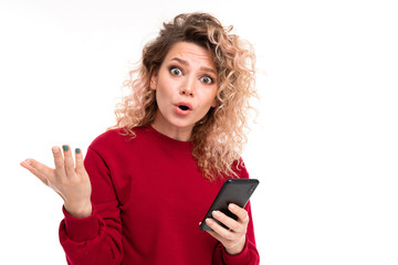 Naklejka premium Caucasian girl with curly fair hair chatting with friends and is surprised