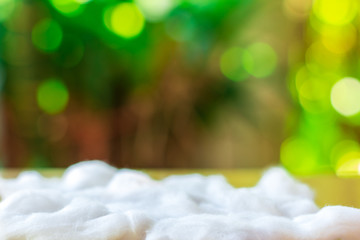White cotton with blurry green bokeh for background.