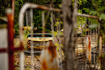 Old bumpy car in Pripyat abandoned amusement park, Chernobyl exclusion zone.