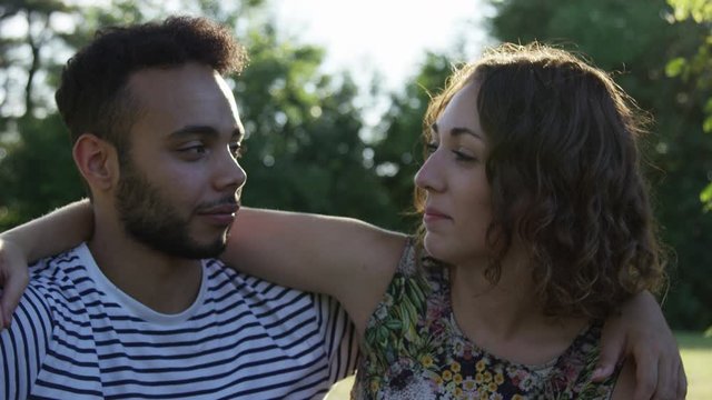 Portrait Multi-Ethnic Young Millennial Couple On A Date In The Park Looking Into The Camera Slow Motion