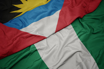 waving colorful flag of nigeria and national flag of antigua and barbuda.