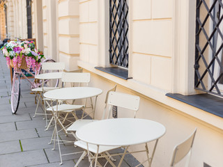 Outdoor street cafe tables ready for service. Tables and chairs of outdoor cafe