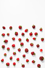 Naklejka na ściany i meble Fresh juicy ripe strawberry on a white surface. Top view.