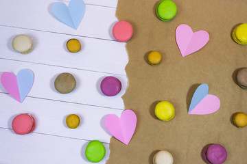 abstract background with hearts. Harvesting for Happy Valentine's Day. Multi-colored macaroons, hearts made of paper.