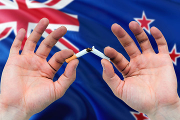 New Zealand quit smoking cigarettes concept. Adult man hands breaking cigarette. National health...