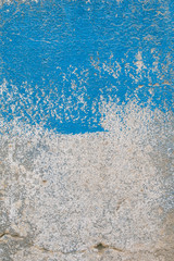 Old cracked wall painted in blue and white as texture and background. Close up view. 