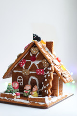 Beautiful decorated gingerbread house with various figures. On white background
