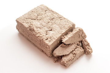 closeup piece halva paste isolated on white