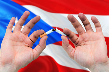 Puerto Rico quit smoking cigarettes concept. Adult man hands breaking cigarette. National health theme and country flag background.