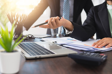 business people planing and pointing on laptop to consult marketing in office