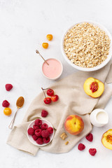 Breakfast with oats, raspberries and peaches. Flatlay with copy space