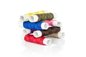 Group of eight whole sewing thread spool tower isolated on white background