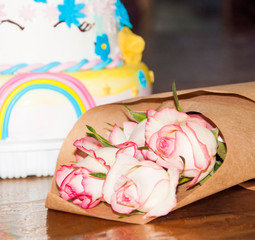 Fruit cake, pink roses bouquet and anniversary presents