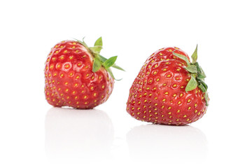 Group of two whole fresh red strawberry isolated on white background
