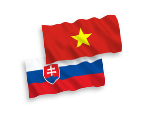 National vector fabric wave flags of Slovakia and Vietnam isolated on white background. 1 to 2 proportion.