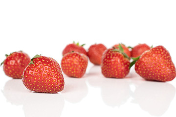 Lot of whole disordered fresh red strawberry isolated on white background