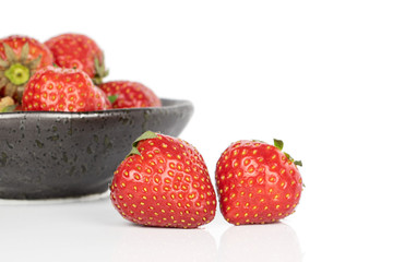 Lot of whole fresh red strawberry in glazed bowl isolated on white background