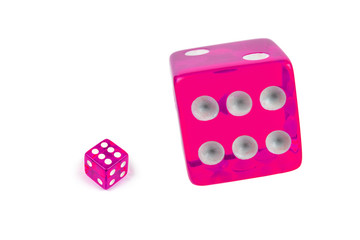 Two pink glass dices isolated on white. Six and flying in the air, view from above.