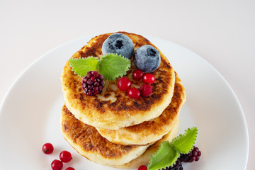 Healthy delicious Breakfast, homemade classic American pancakes with fresh berries, morning. Light background.