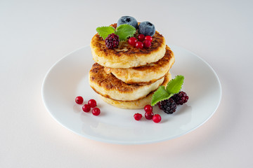 Healthy delicious Breakfast, homemade classic American pancakes with fresh berries, morning. Light background.