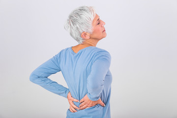 Matur Woman suffering from lower back pain. Mature woman resting with back pain. Female lower back...