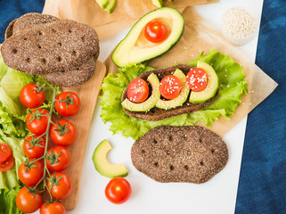 Healthy food. Vegetable appetizers. Sandwich. Rye Bread, Avocado, Lettuce, Cherry Tomatoes