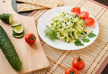 Healthy food. Appetizer. Fresh cucumber salad with onion, dill and cherry tomatoes