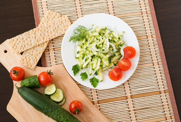 Healthy food. Appetizer. Fresh cucumber salad with onion, dill and cherry tomatoes