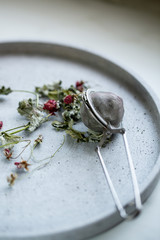 Herbal tea with dried raspberry and leaves on stone background with copy space