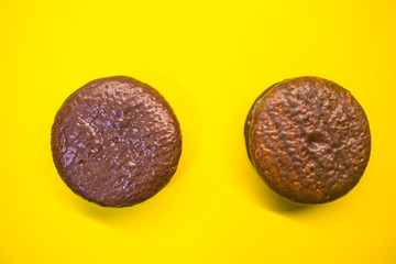 Chocolate chip cookies on a yellow background two pieces