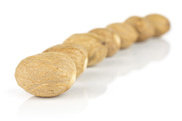 Lot of whole dry brown nutmeg isolated on white background