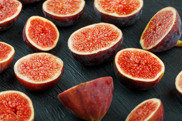 Ripe sweet figs on a black background.
