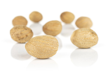 Fototapeta na wymiar Group of eight whole dry brown nutmeg isolated on white background