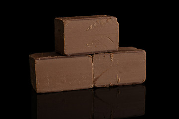 Group of three whole sweet brown viennese nougat isolated on black glass