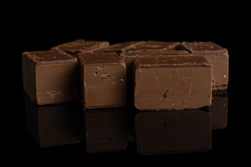 Lot of whole sweet brown viennese nougat isolated on black glass