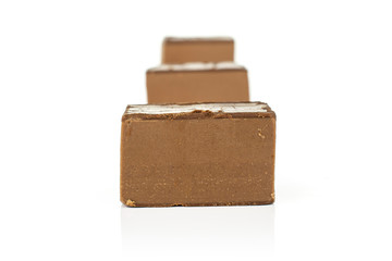 Group of three whole sweet brown viennese nougat in line isolated on white background