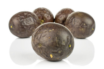Group of five whole sweet dark purple passion fruit isolated on white background
