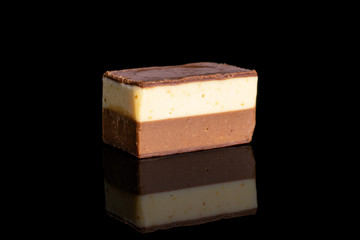 One whole delicious chocolate praline isolated on black glass