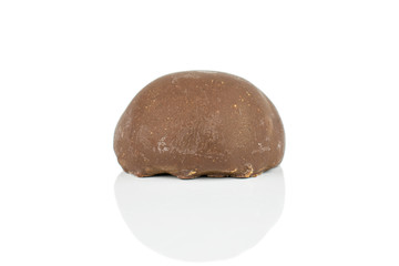 One whole dark brown delicious chocolate praline isolated on white background