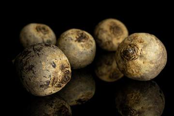 Fototapeta premium Group of five whole raw red beetroot isolated on black glass