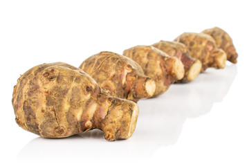 Group of six whole fresh brown jerusalem artichoke isolated on white background