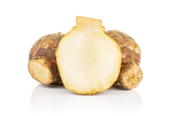 Group of two whole one half of fresh brown jerusalem artichoke isolated on white background