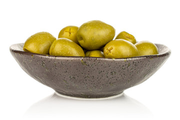 Lot of whole pitted green olive in dark ceramic bowl isolated on white background