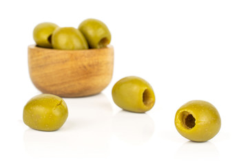 Group of six whole pitted green olive in tiny wooden bowl isolated on white background