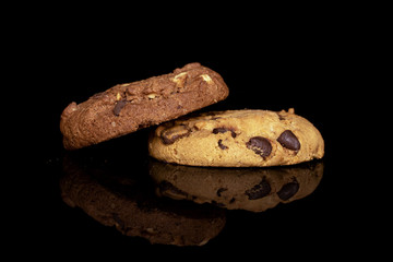 Group of two whole sweet brown cookie isolated on black glass